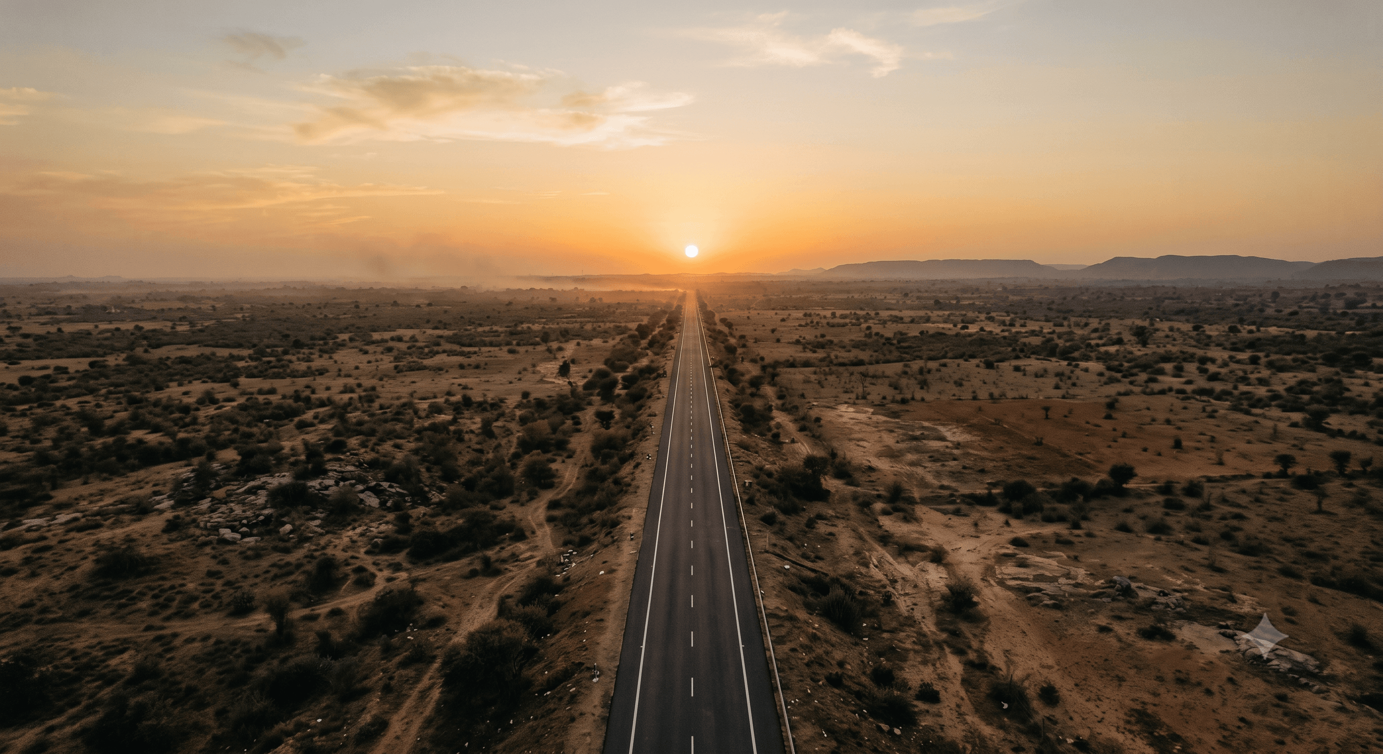 A highway crossing the Rajasthan plains at dusk